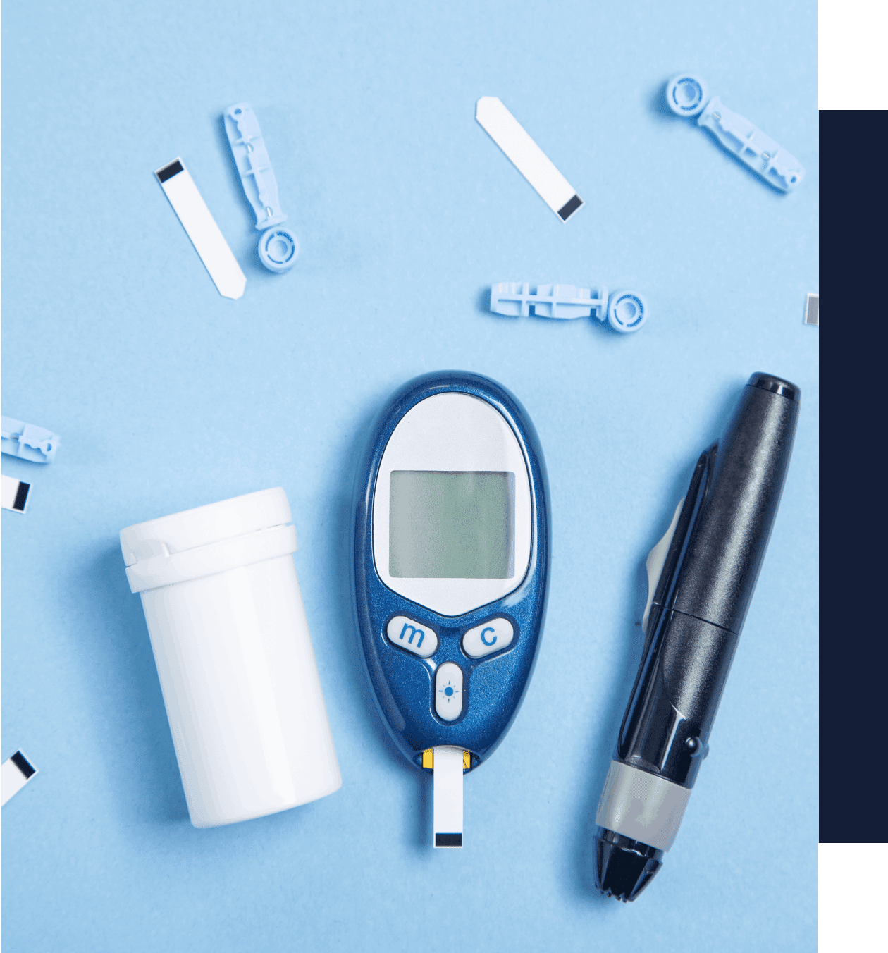 A blue and white table with some pills, a pen, and a glucose meter.
